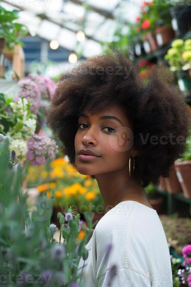 Black Business Woman in a Garden Center Surrounded by Greenery photo