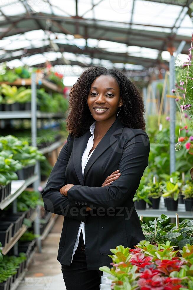 Black Business Woman in a Garden Center Surrounded by Greenery photo