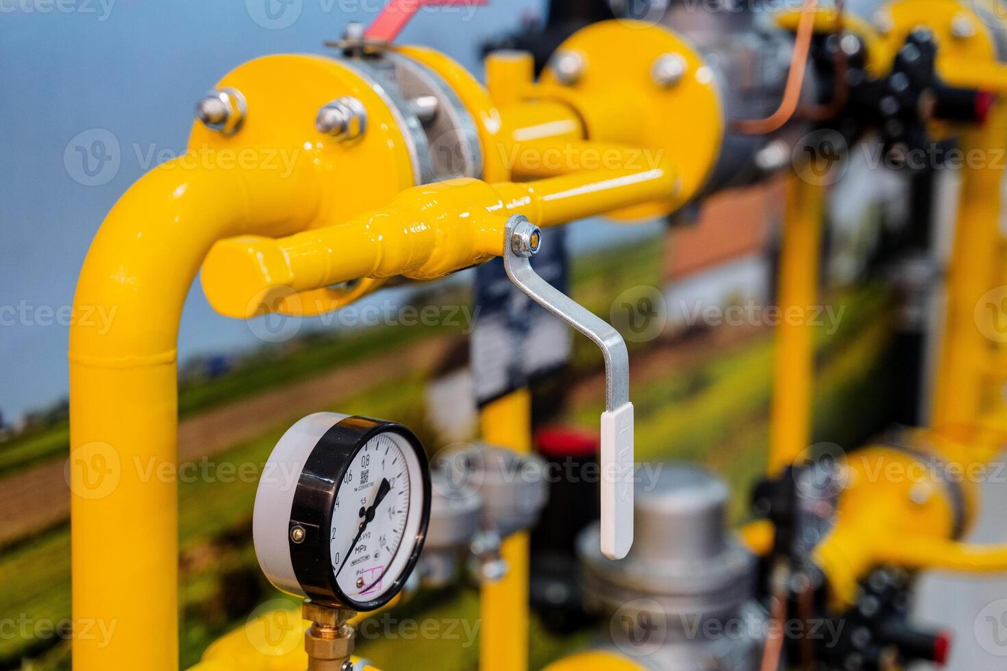 Valve connection of pipes under pressure, barometer of atmospheric voltage, yellow gas pipes, oil products plant, water shut-off valve. photo