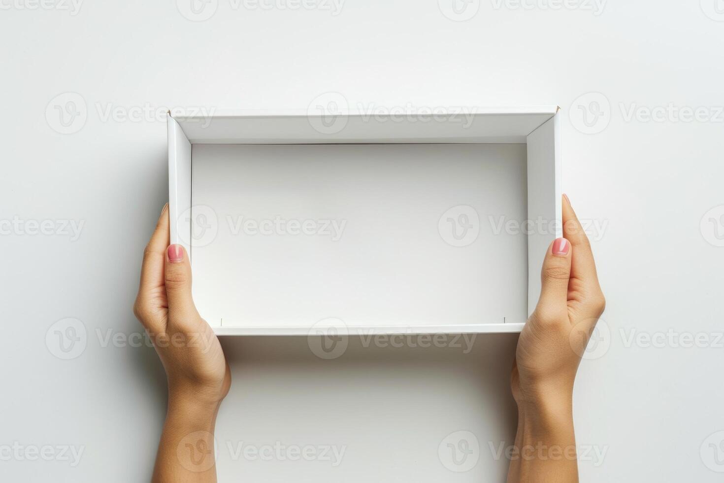 Woman opens white box in top view studio shot. photo