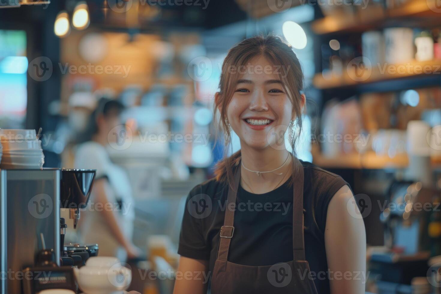 young smiling asian waitress serving customers in coffee shop focus on the background girl. photo