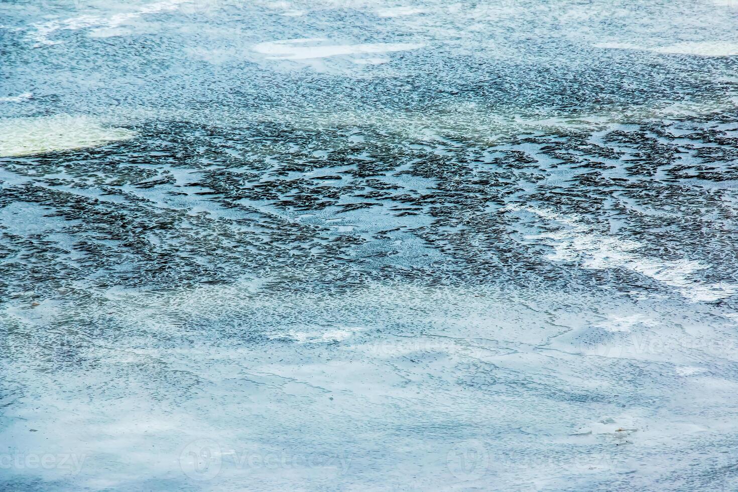 Ice surface of the river. Texture of ice shards and water. Winter background photo
