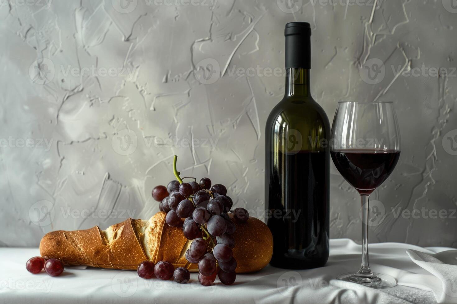 Wine bottle and wine glass still life with grapes and bread on white plaster background. Wine photo