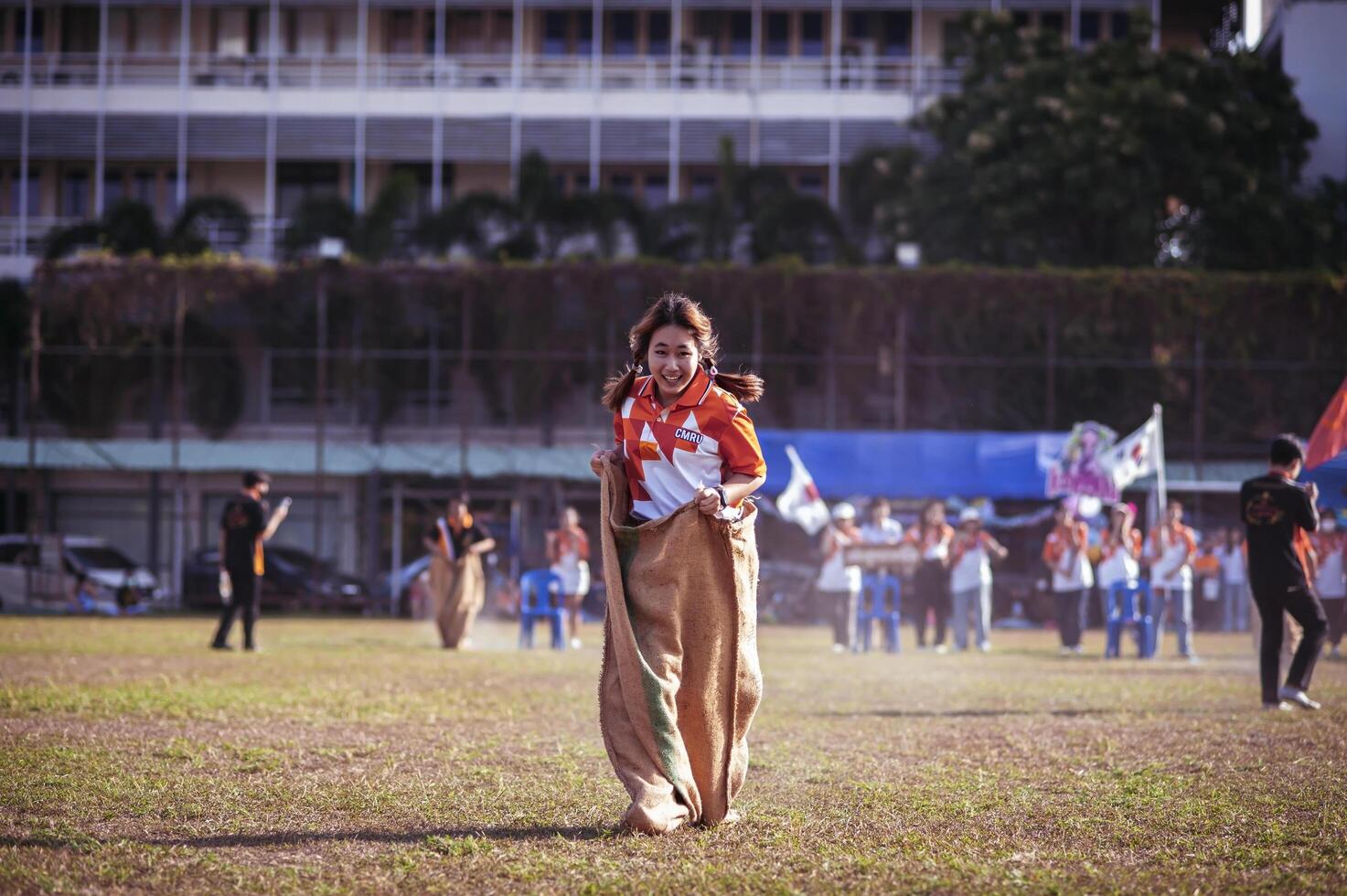 ChiangMai Thailand November 30 2022 Asian teenage students are doing a sack race for unity in Chiang Mai Rajabhat University photo