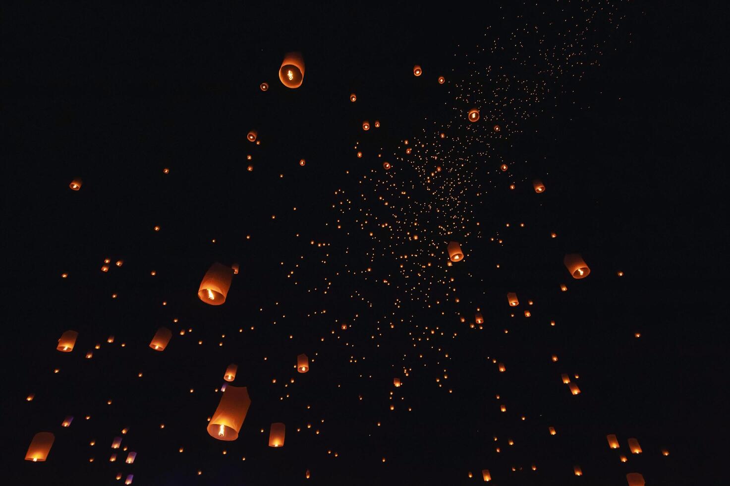 The beauty of the lanterns floating in the sky during the Yi Peng Festival and the Floating Lantern Festival in Chiang Mai Province, Thailand. photo
