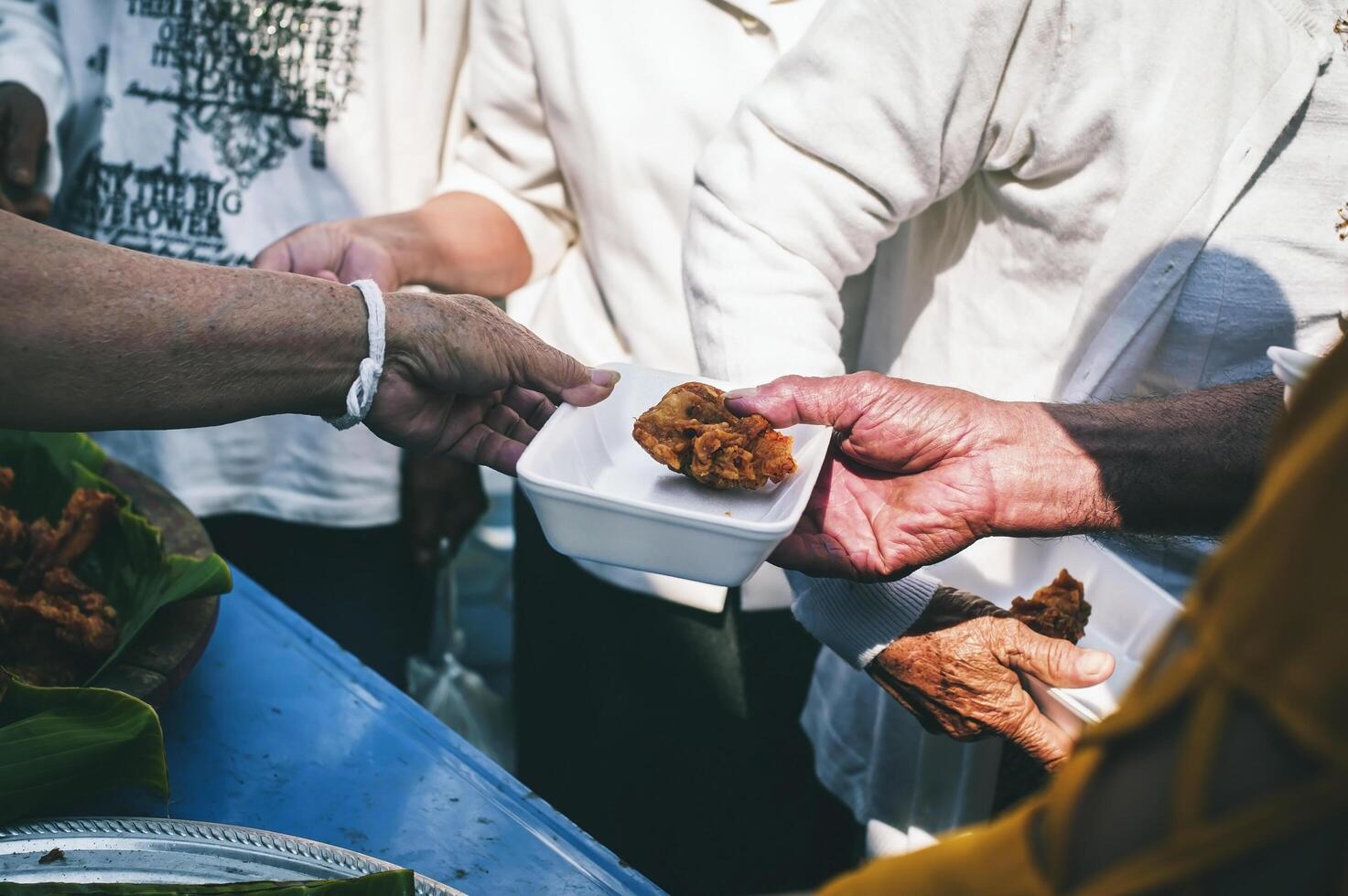Volunteers distribute free food to the poor charity food ideas photo