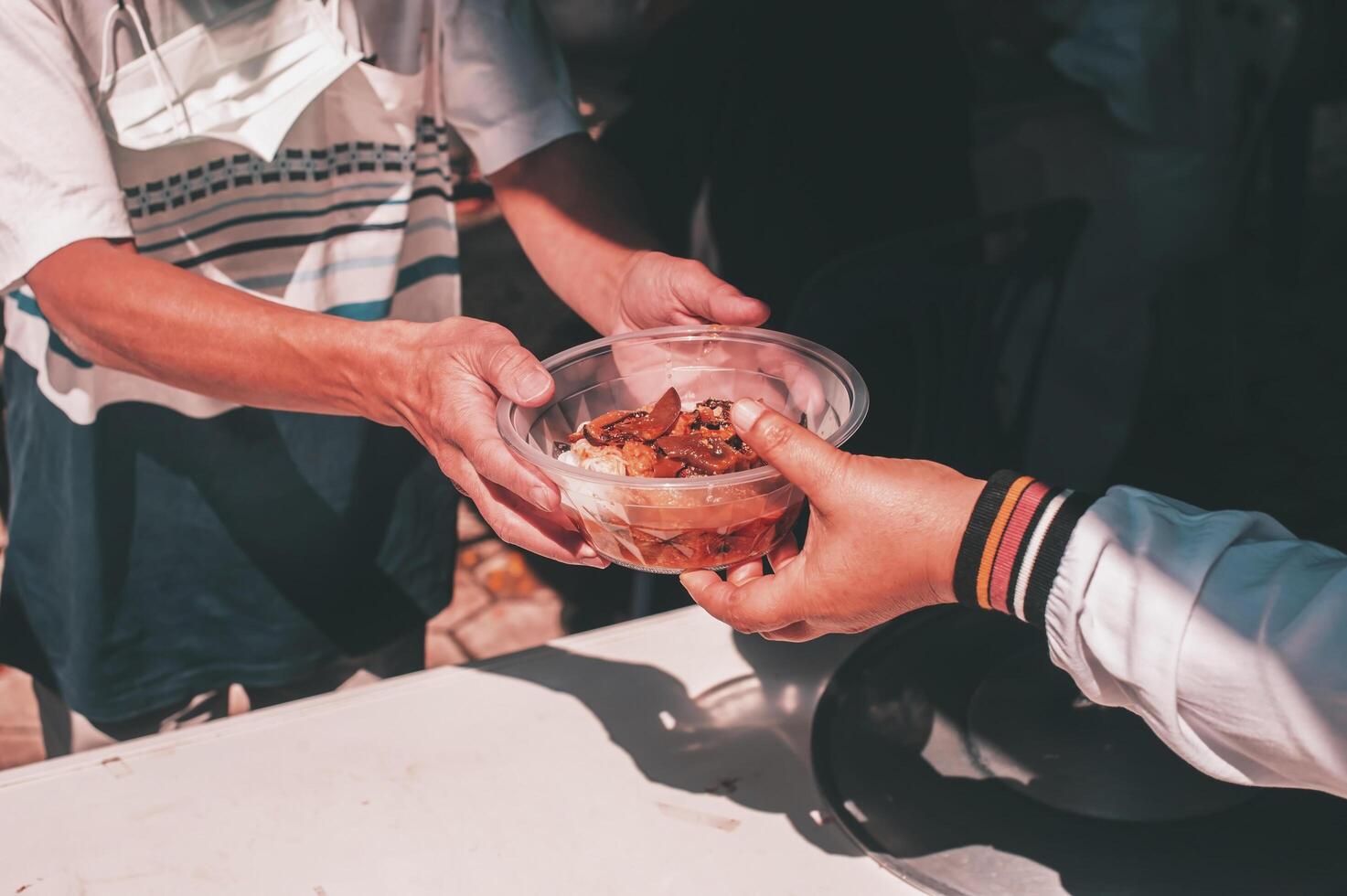Food donations to fight hunger by sharing free food with people photo