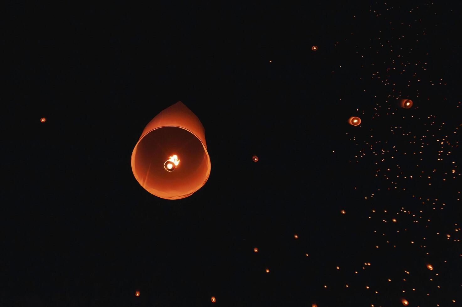 The beauty of the lanterns floating in the sky during the Yi Peng Festival and the Floating Lantern Festival in Chiang Mai Province, Thailand. photo