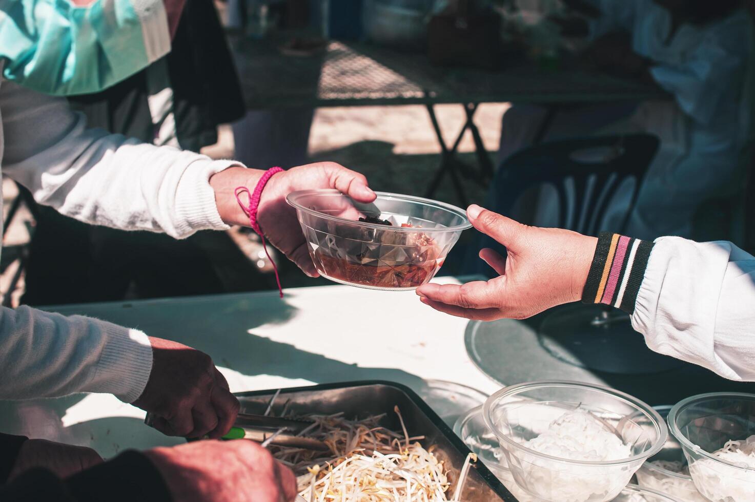 Hungry homeless people request free food donations from volunteers social concept of helping photo