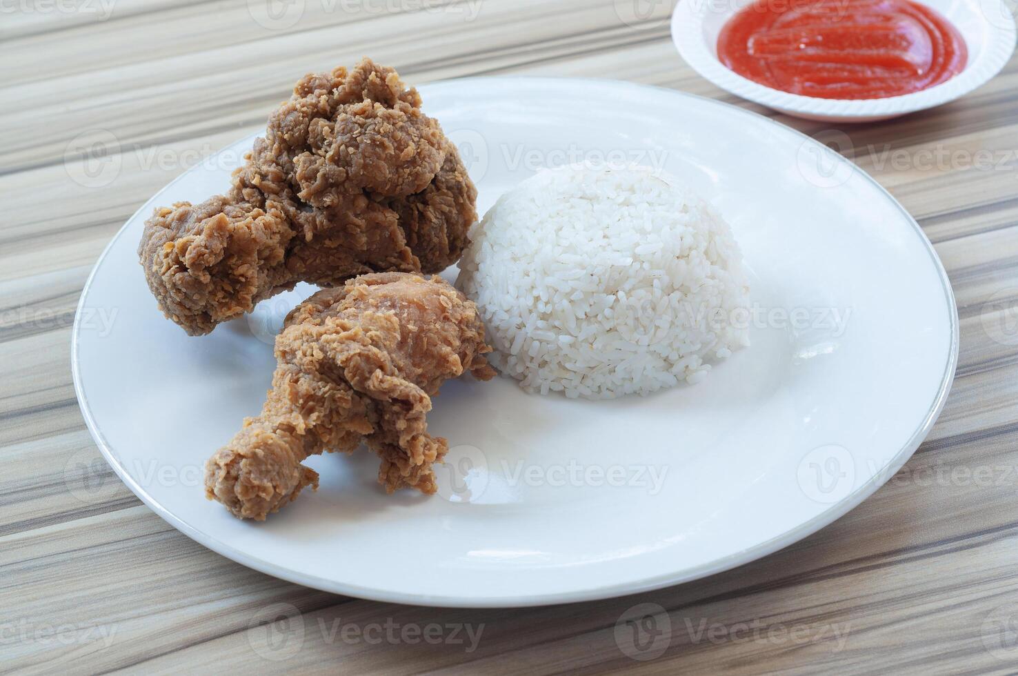 Fried Chicken with white rice and Vegetables as garnish photo