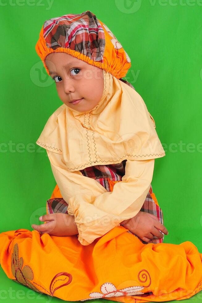 portrait of Indonesian little girl wearing hijab dress photo