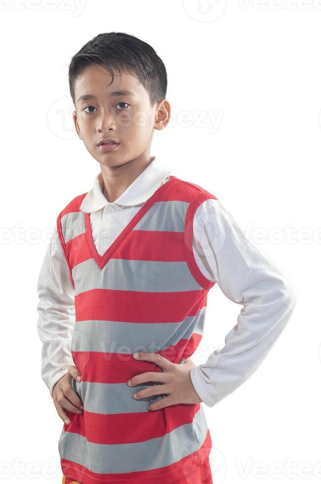 an indonesian 10 years old boy wearing red stripe sweater with confidence arm pose photo