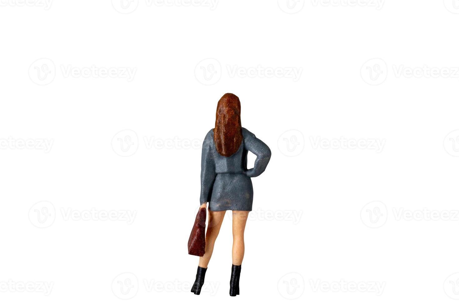 Miniature Business Woman holding suitcase standing isolated on white background with clipping path photo