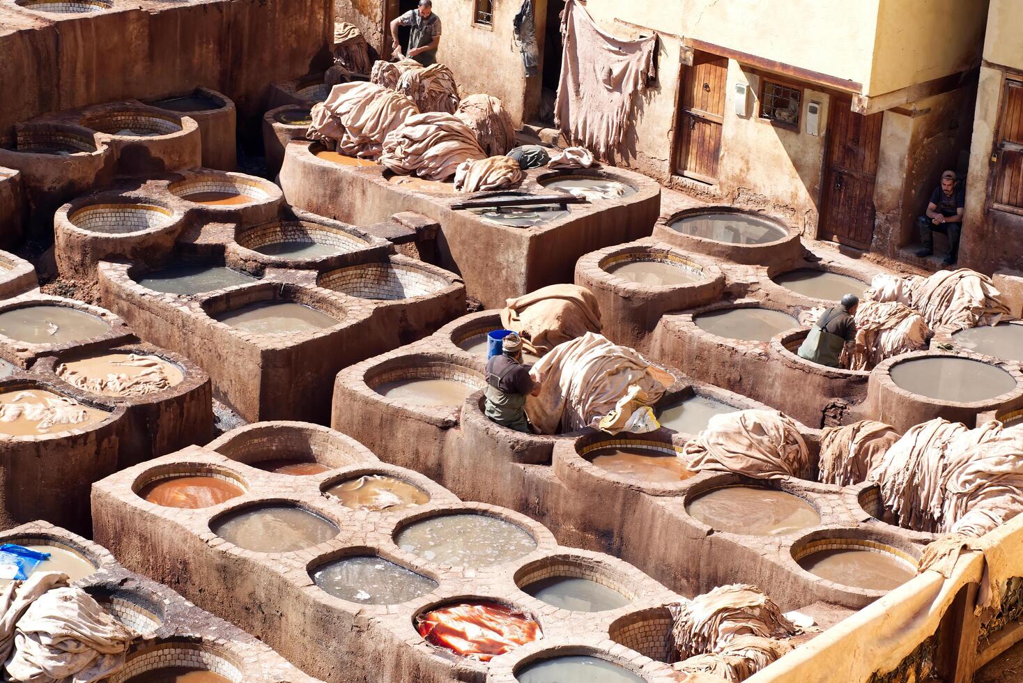 Fes Morocco Africa- February 17, 2024 Leather dying in the traditional Chouara Tannery in the city of Fes. Morocco, Africa. photo