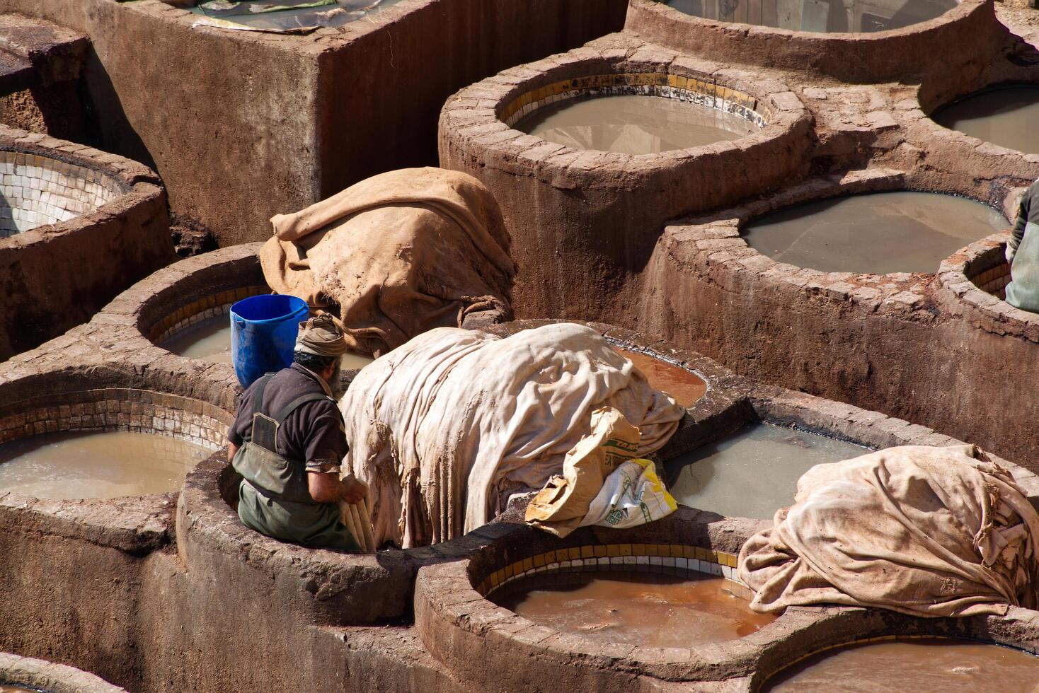 Fes Morocco Africa February 17, 2024 Leather dying in the traditional Chouara Tannery in Fes. photo