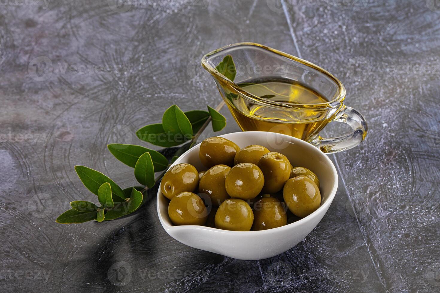 Ripe tasty green olives with branch photo