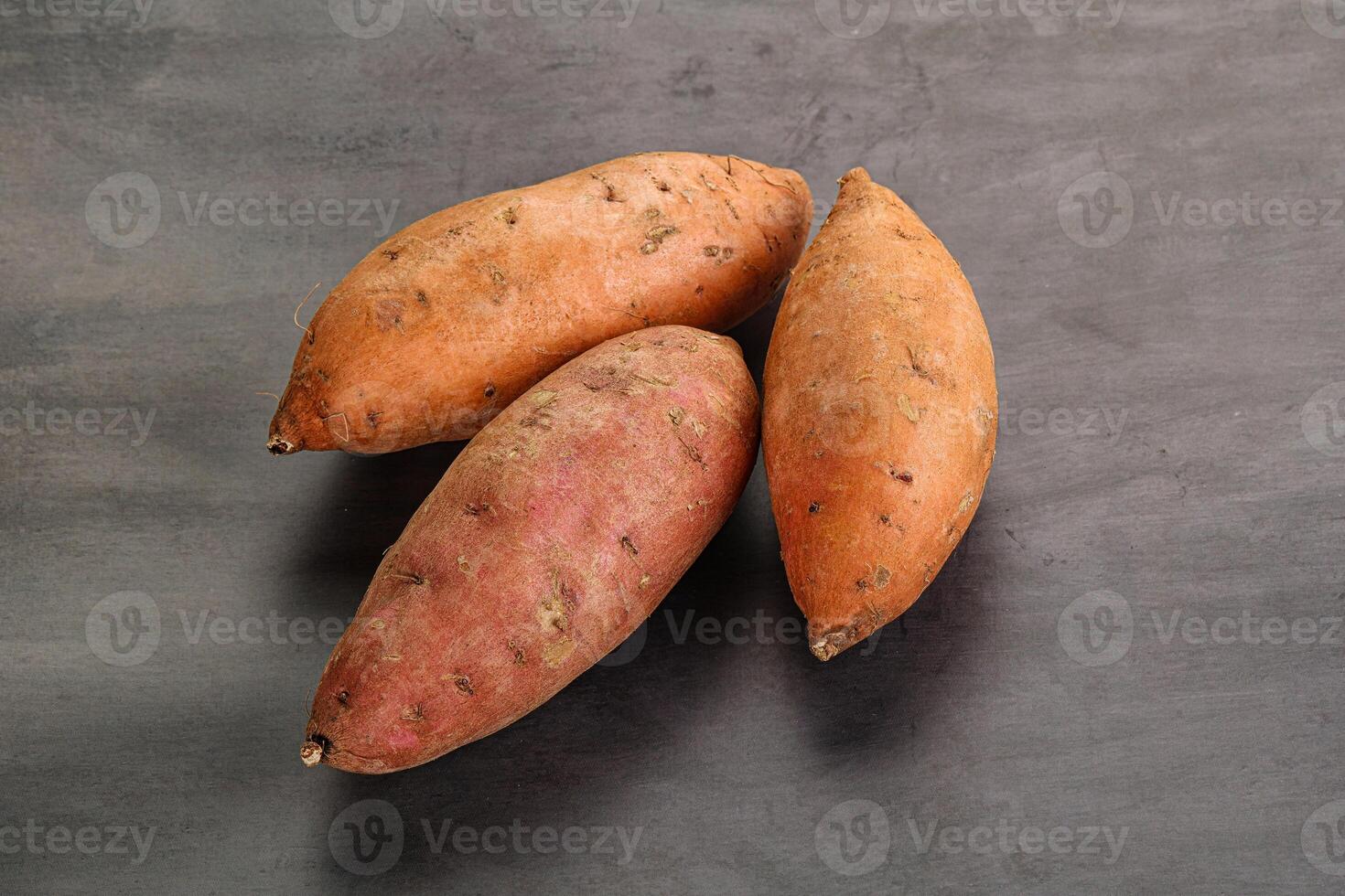 Raw ripe sweet potato heap photo