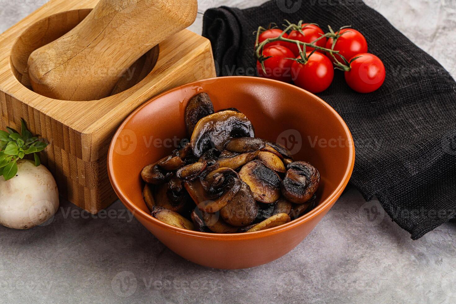 Roasted champignon mushrooms in the bowl photo