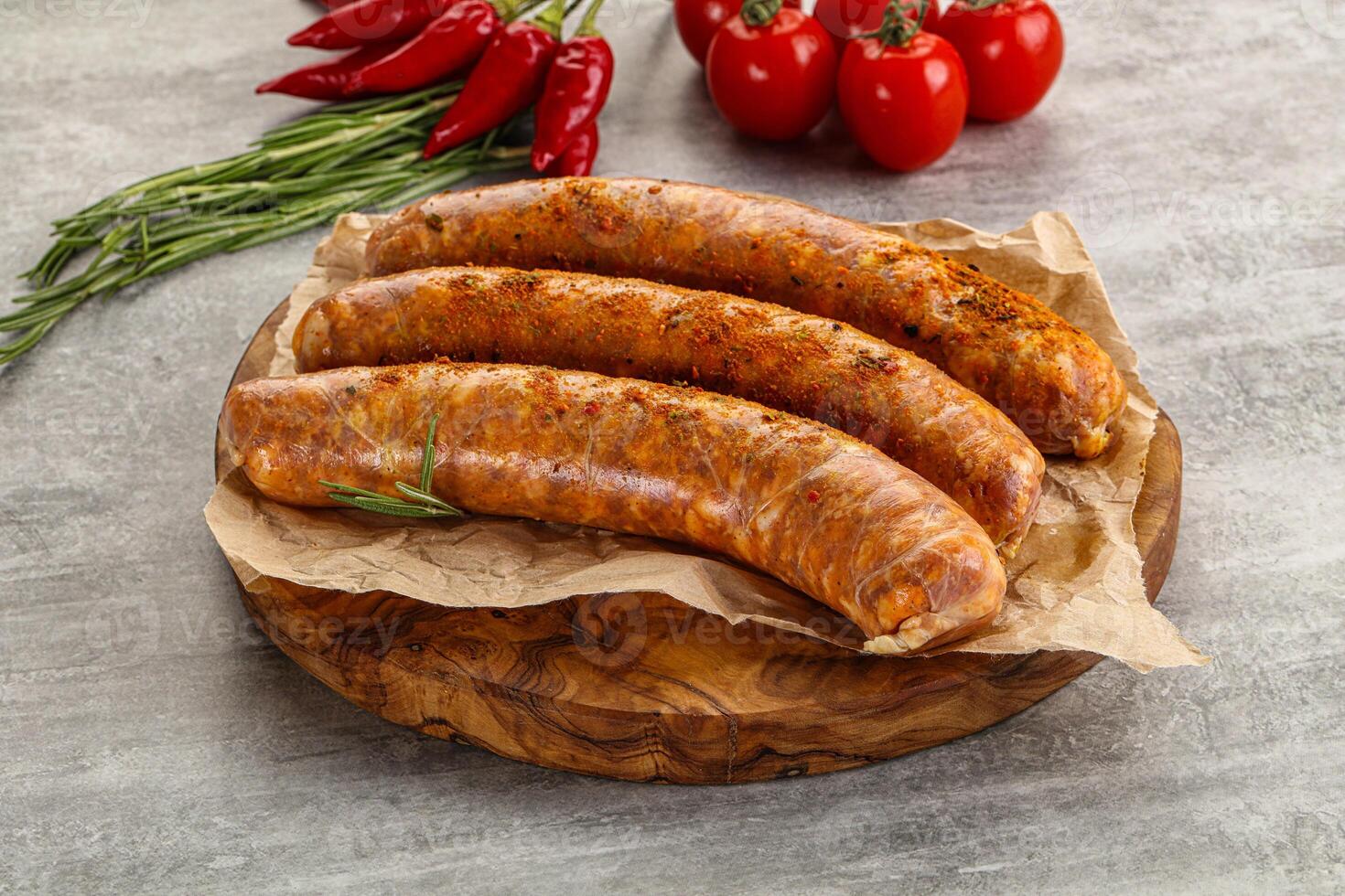 Raw sausages with spices and herbs photo