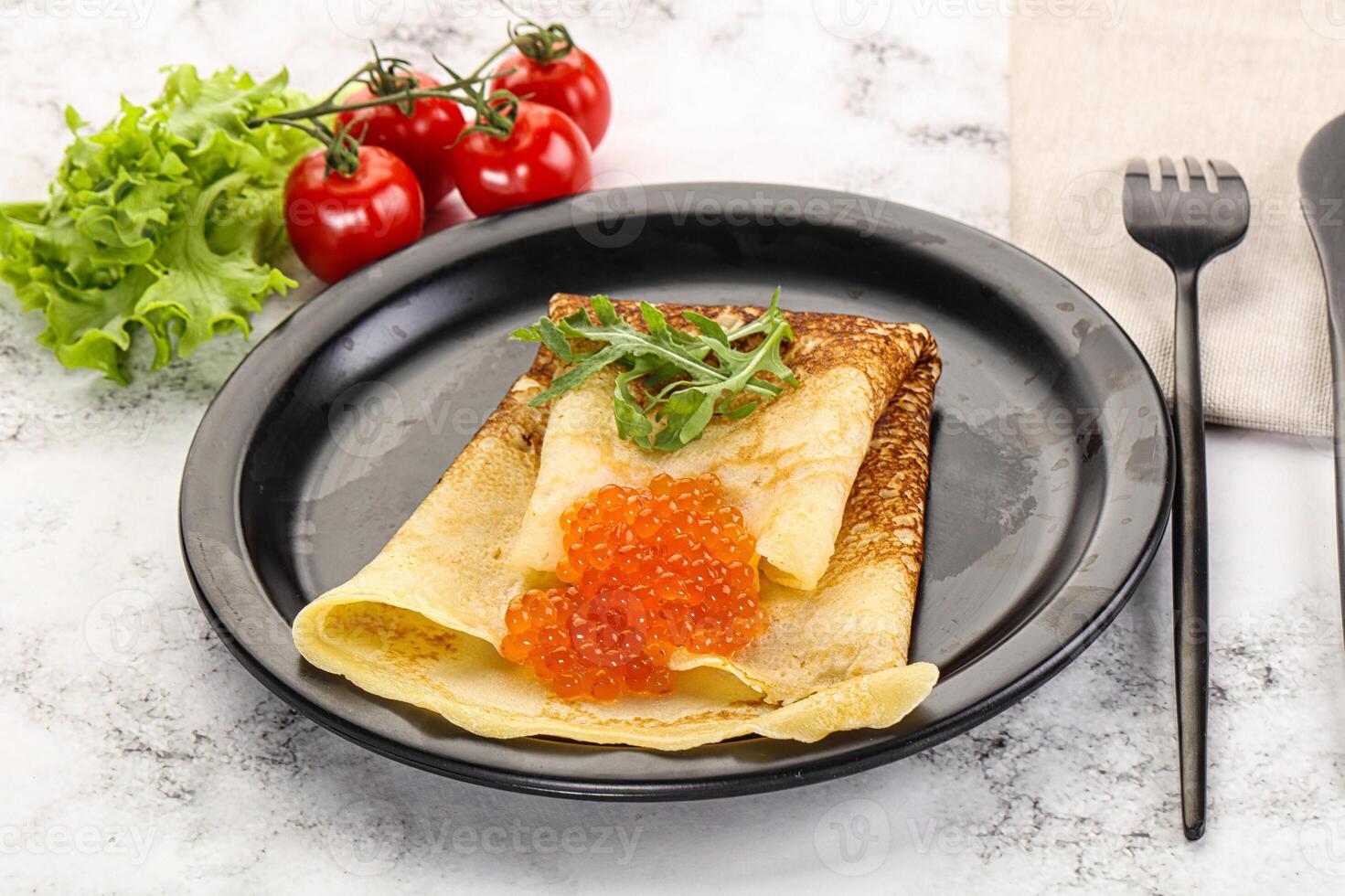 Russian pancake with red caviar photo