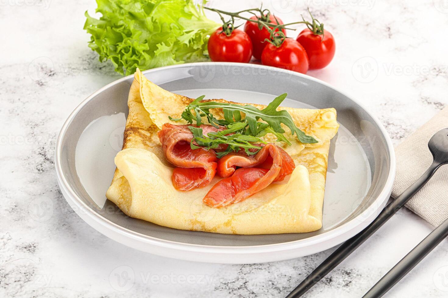 Russian pancake with salmon fish photo