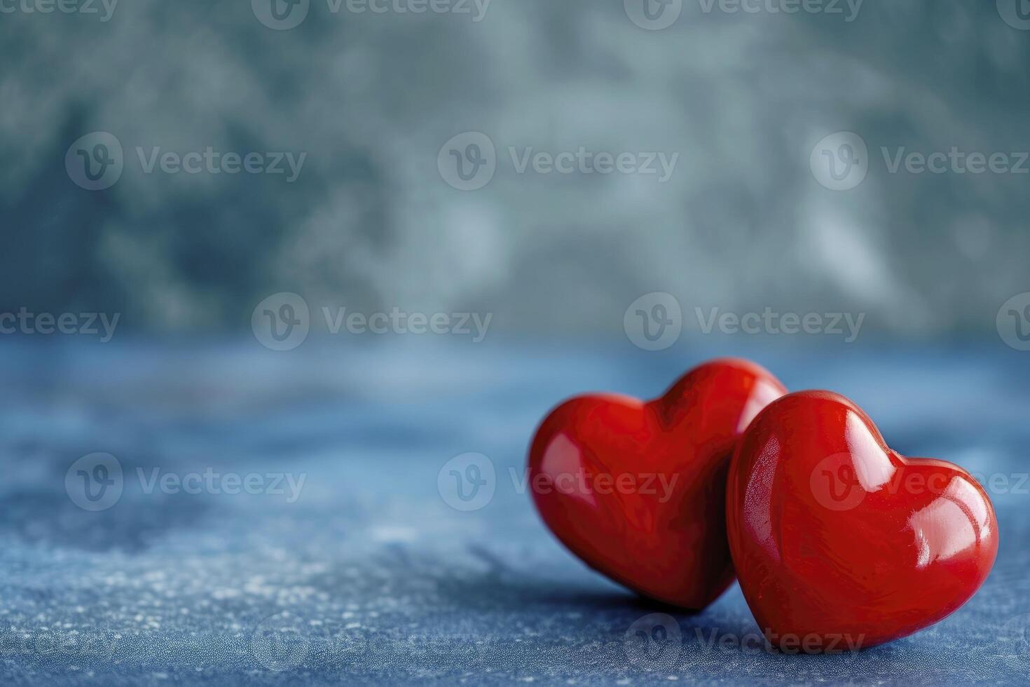 Valentines Day concept two red hearts on a blue background photo