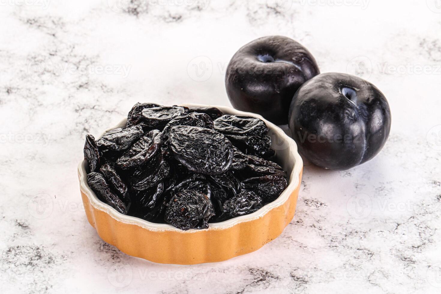 Dry prunes in thw bowl photo