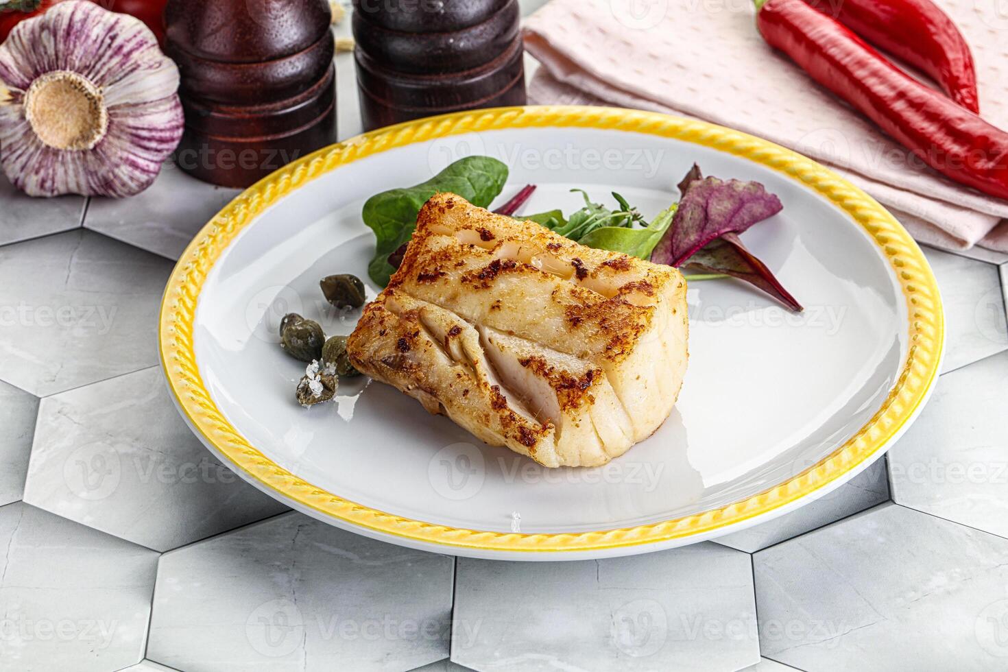 Roasted cod fish steak with salad photo