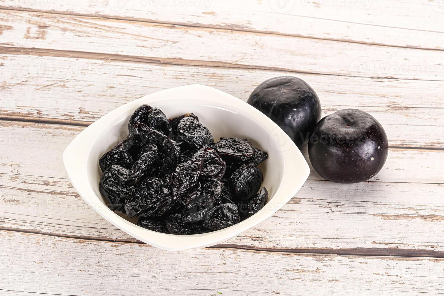 Dry prunes in thw bowl photo