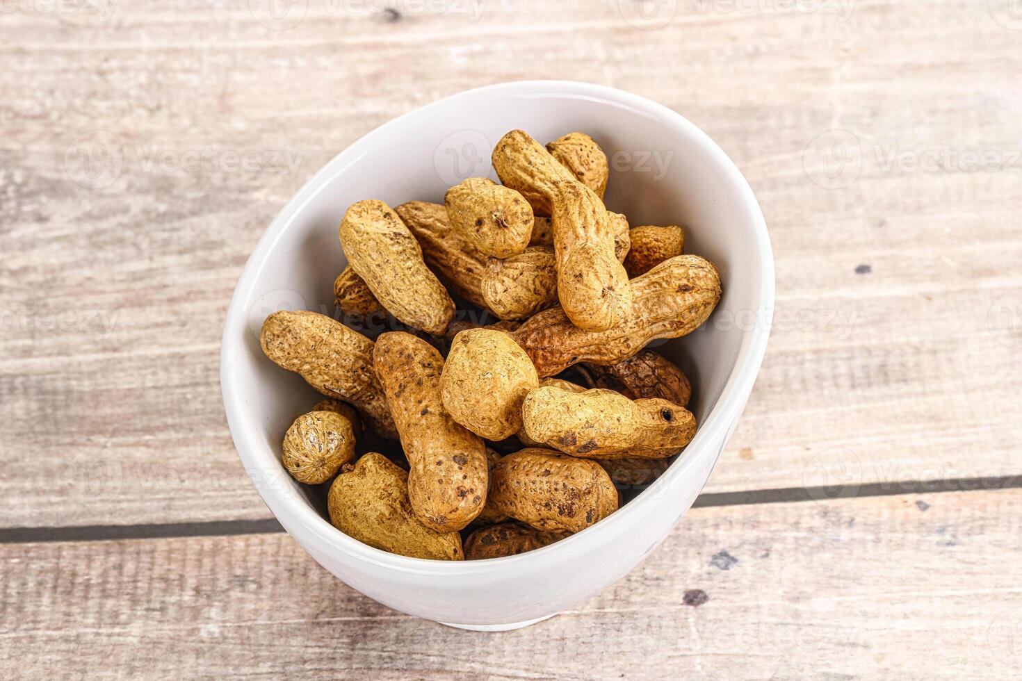 Raw ripe unpeeled peanut heap photo