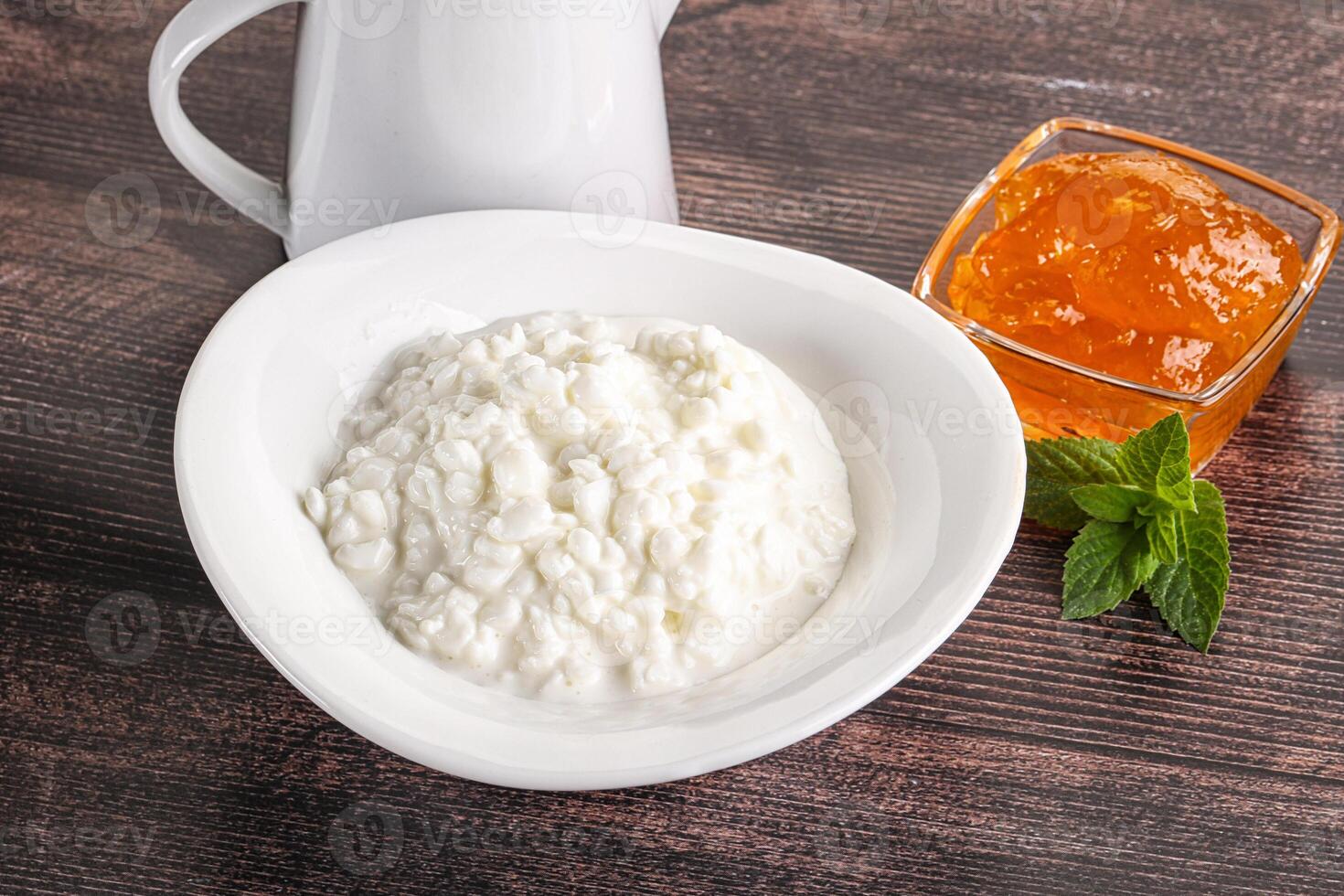 Grain curd with cream and jam photo
