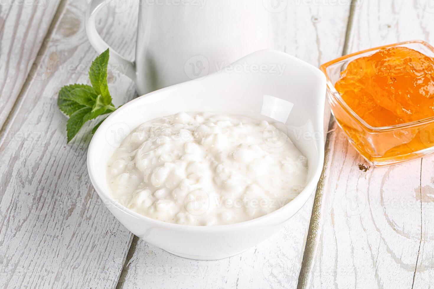 Grain curd with cream and jam photo