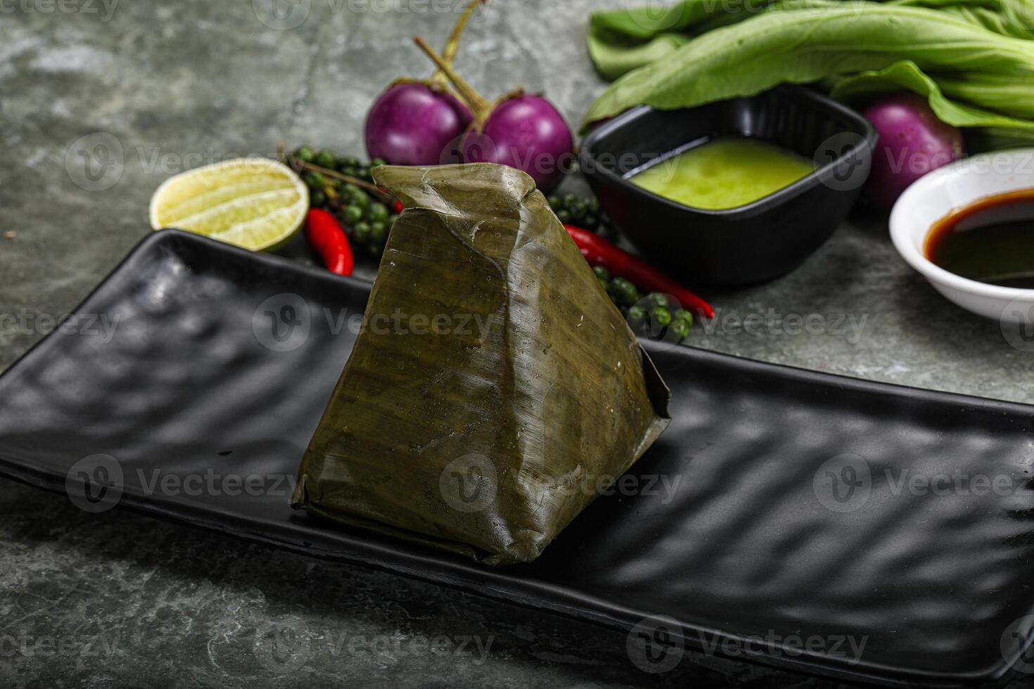 Asian cuisine - rice with filling in banana leaf photo