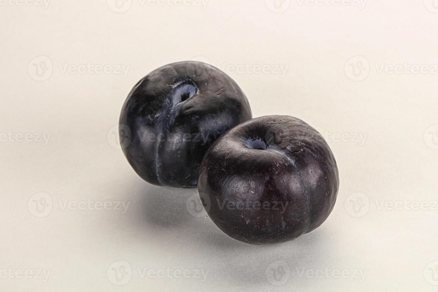 Two ripe sweet black plums photo