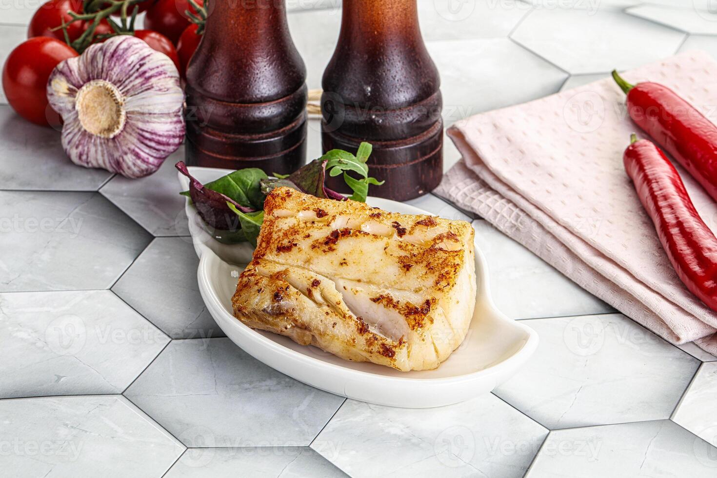 Roasted cod fish steak with salad photo