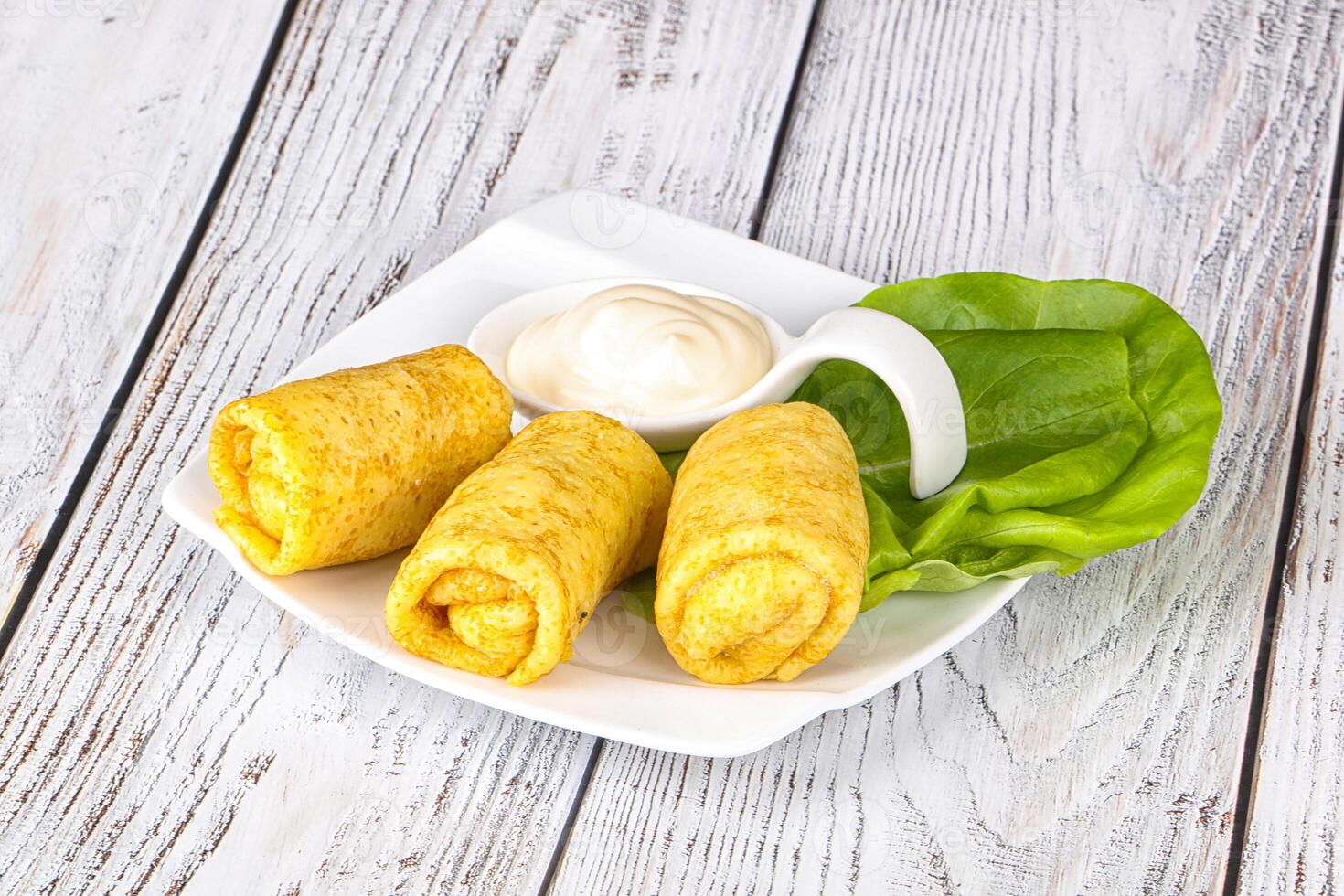 Stuffed pancakes with cream sauce photo