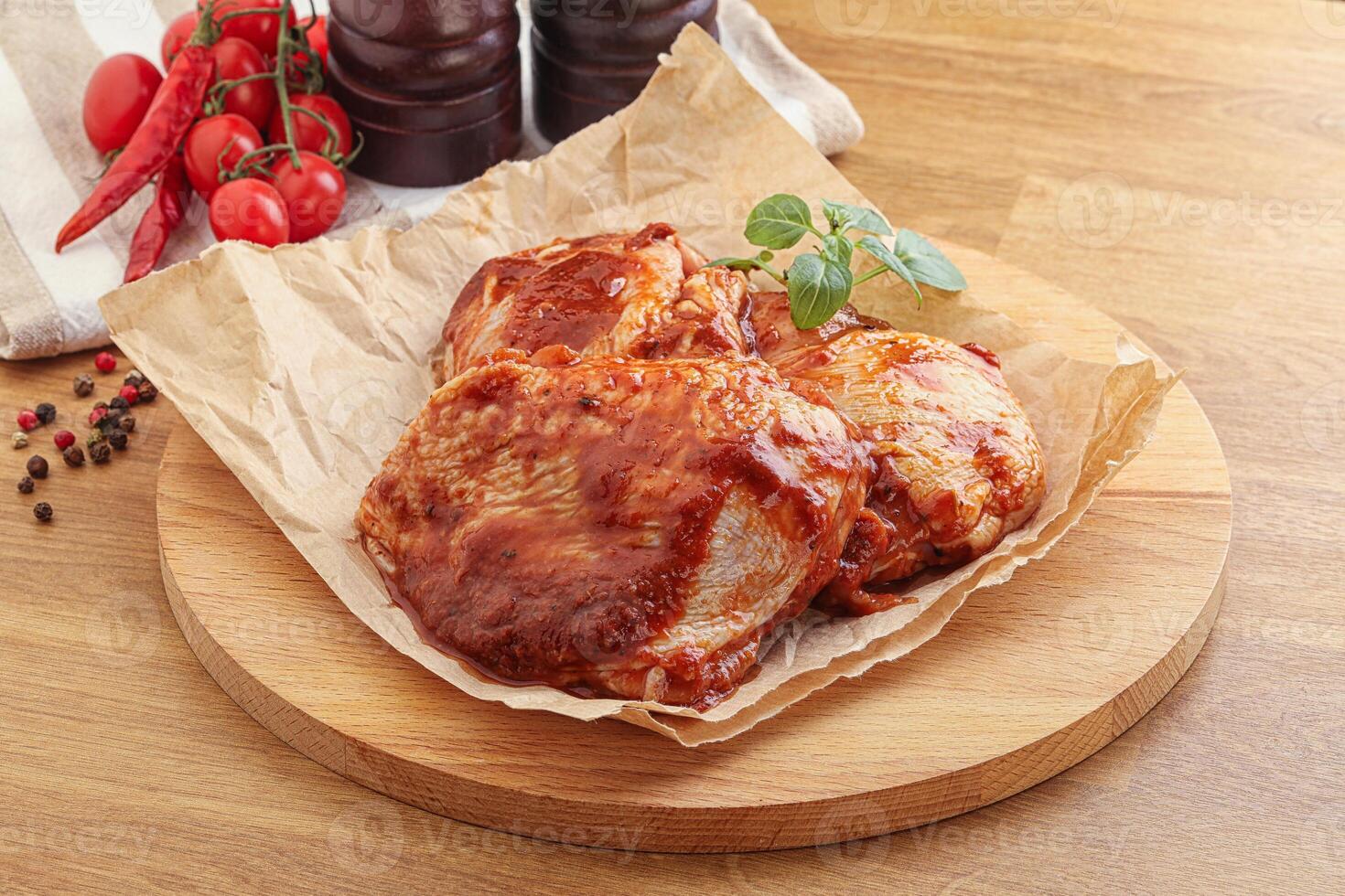 Marinated chicken leg in tomato sauce photo