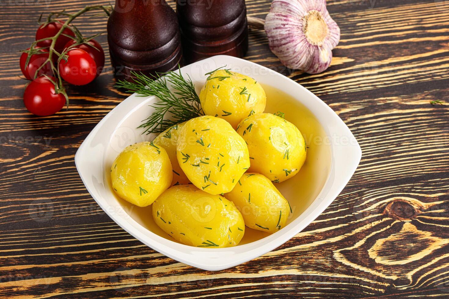 Boiled potato with oil and dill photo