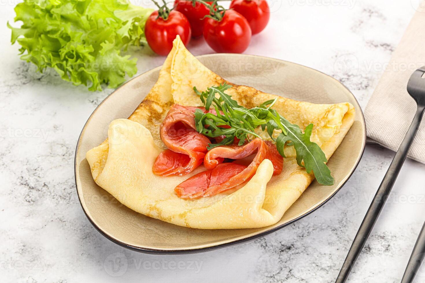 Russian pancake with salmon fish photo