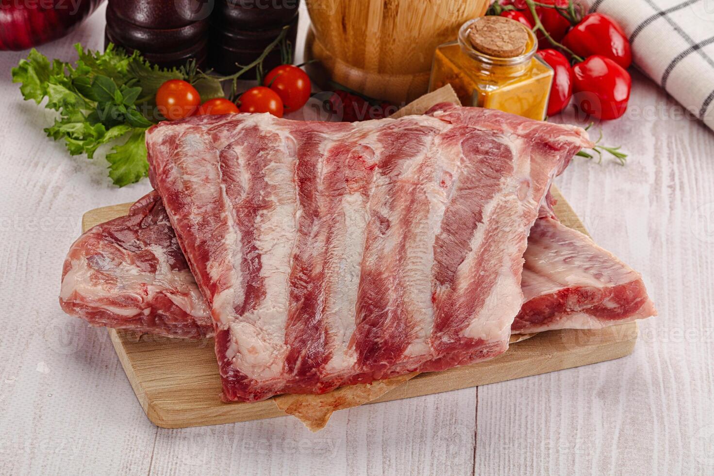 Raw pork ribs over board photo