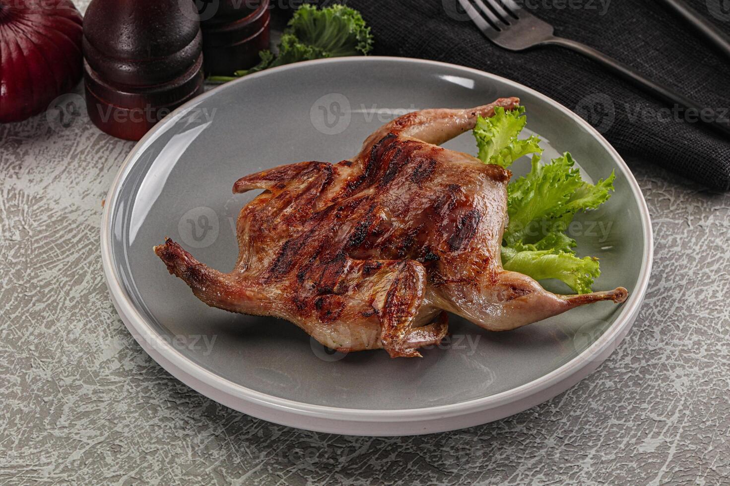 Grilled quail in the plate photo