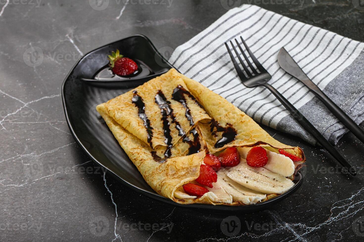 Sweet pancake with banana and strawbeery photo
