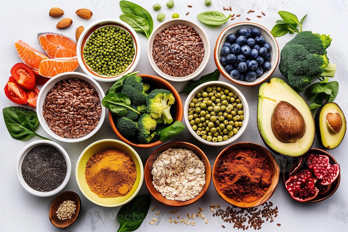 Assortment of superfoods with vibrant fruits, vegetables, and seeds on a white background for a healthy diet photo