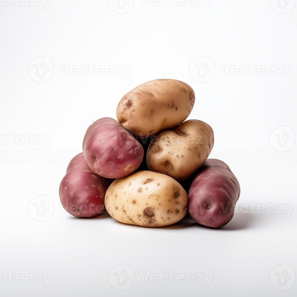 Pile of assorted red and white potatoes, freshly harvested, isolated on a white background photo