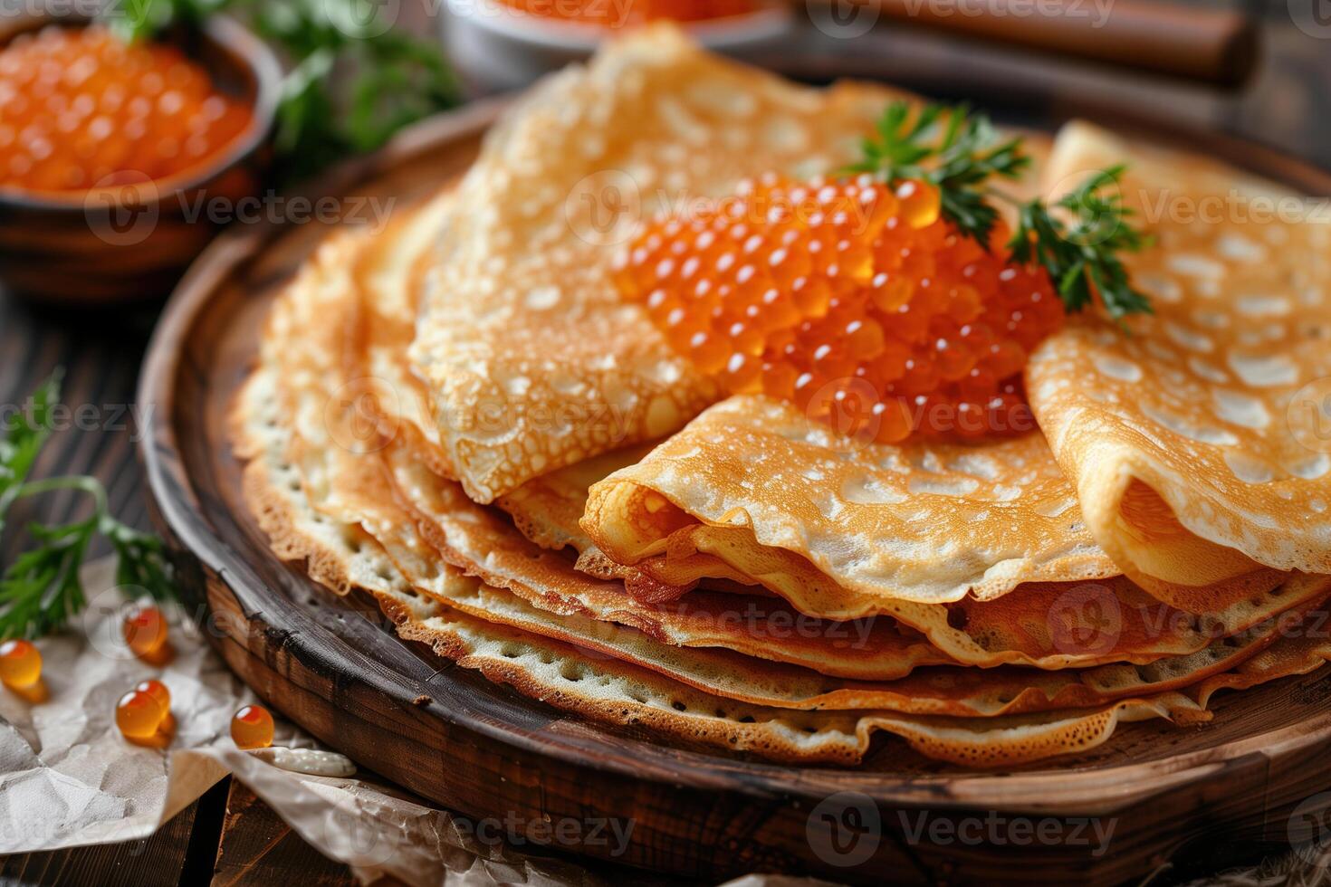A stack of pancakes with a garnish of berries and a sprig of parsley photo