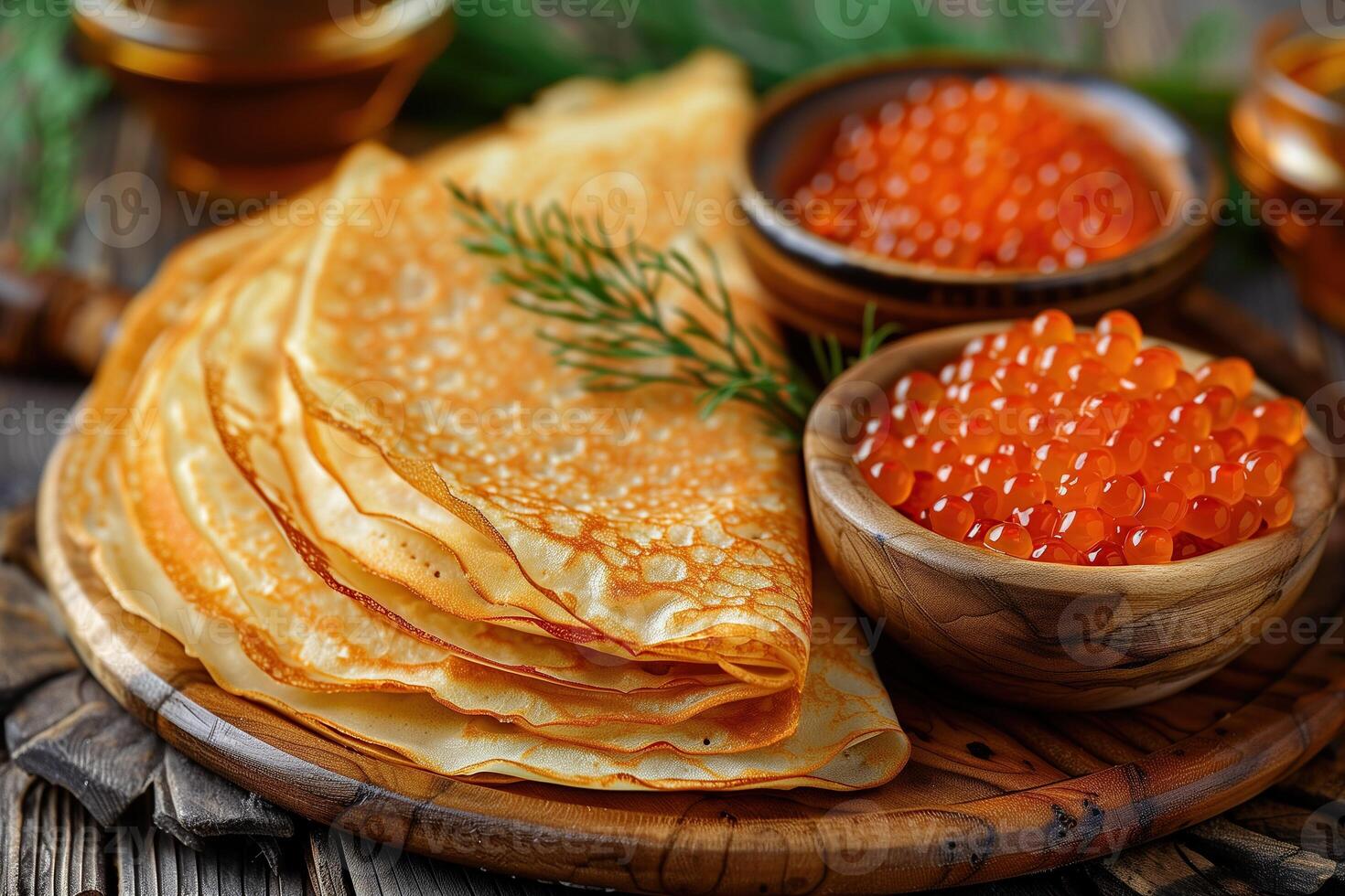 A plate of pancakes with a bowl of caviar on the side photo