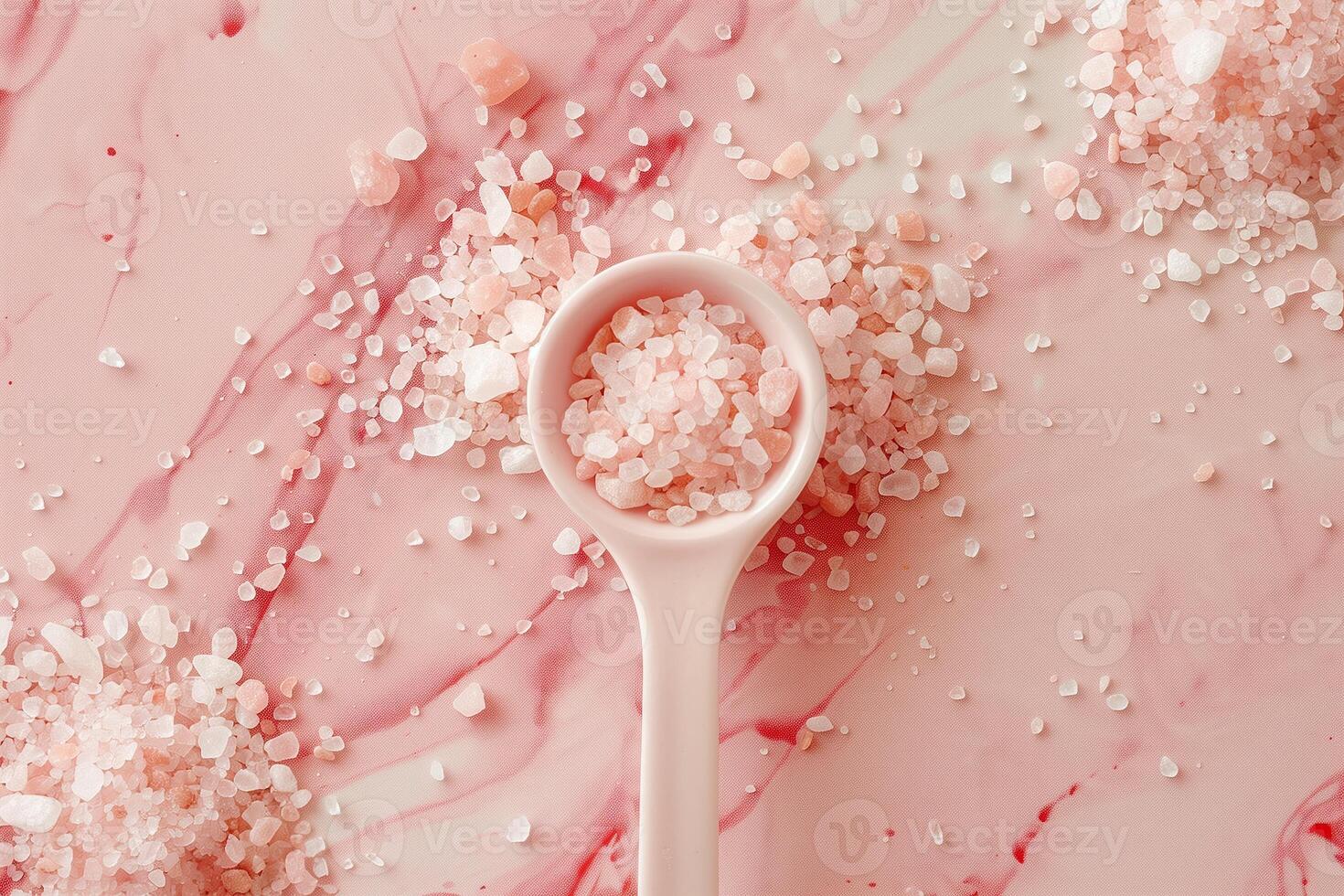 A pink spoon with salt on it photo