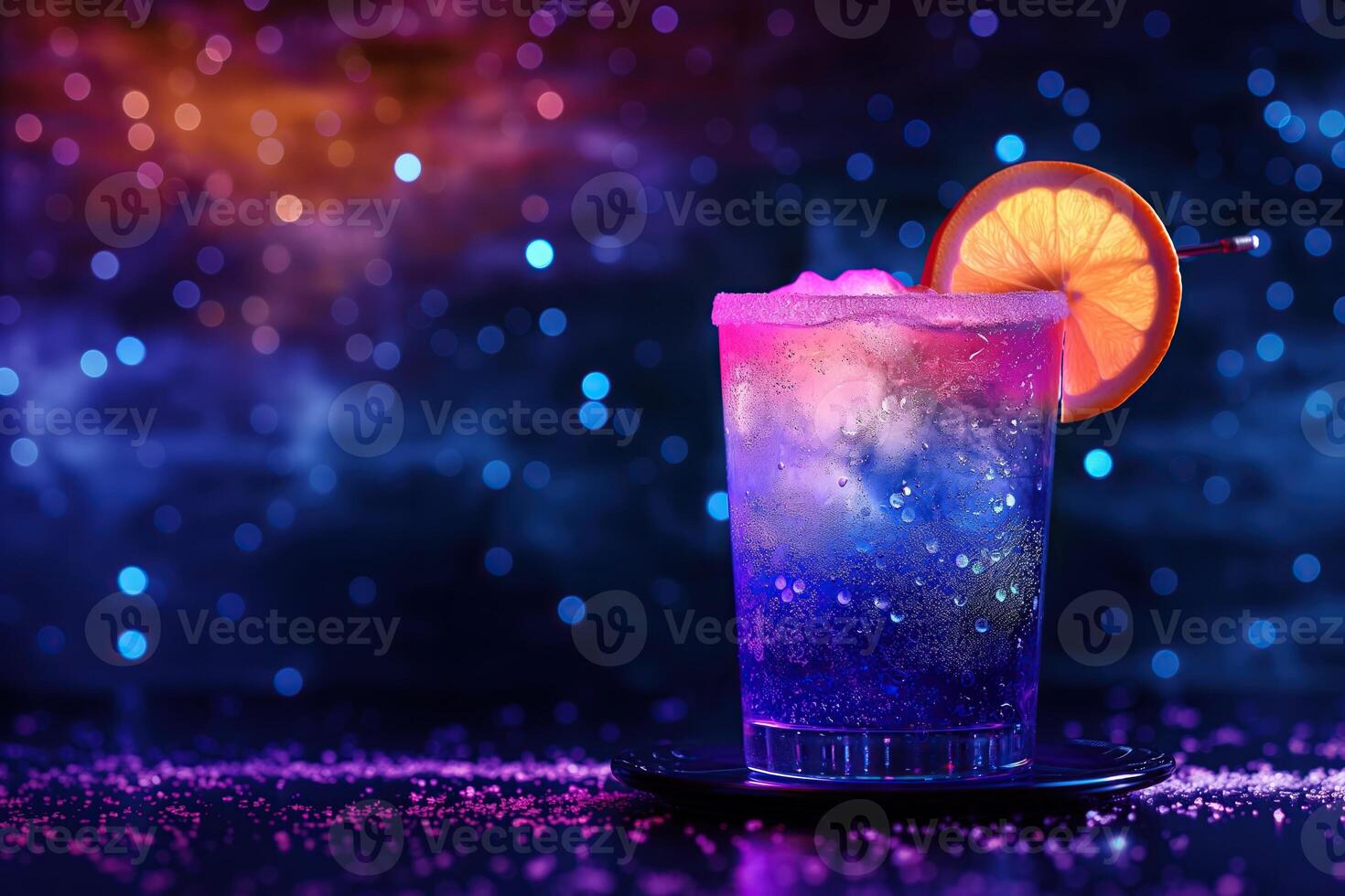 A cosmic neon cocktail drink with a slice of orange on top is served in a glass photo