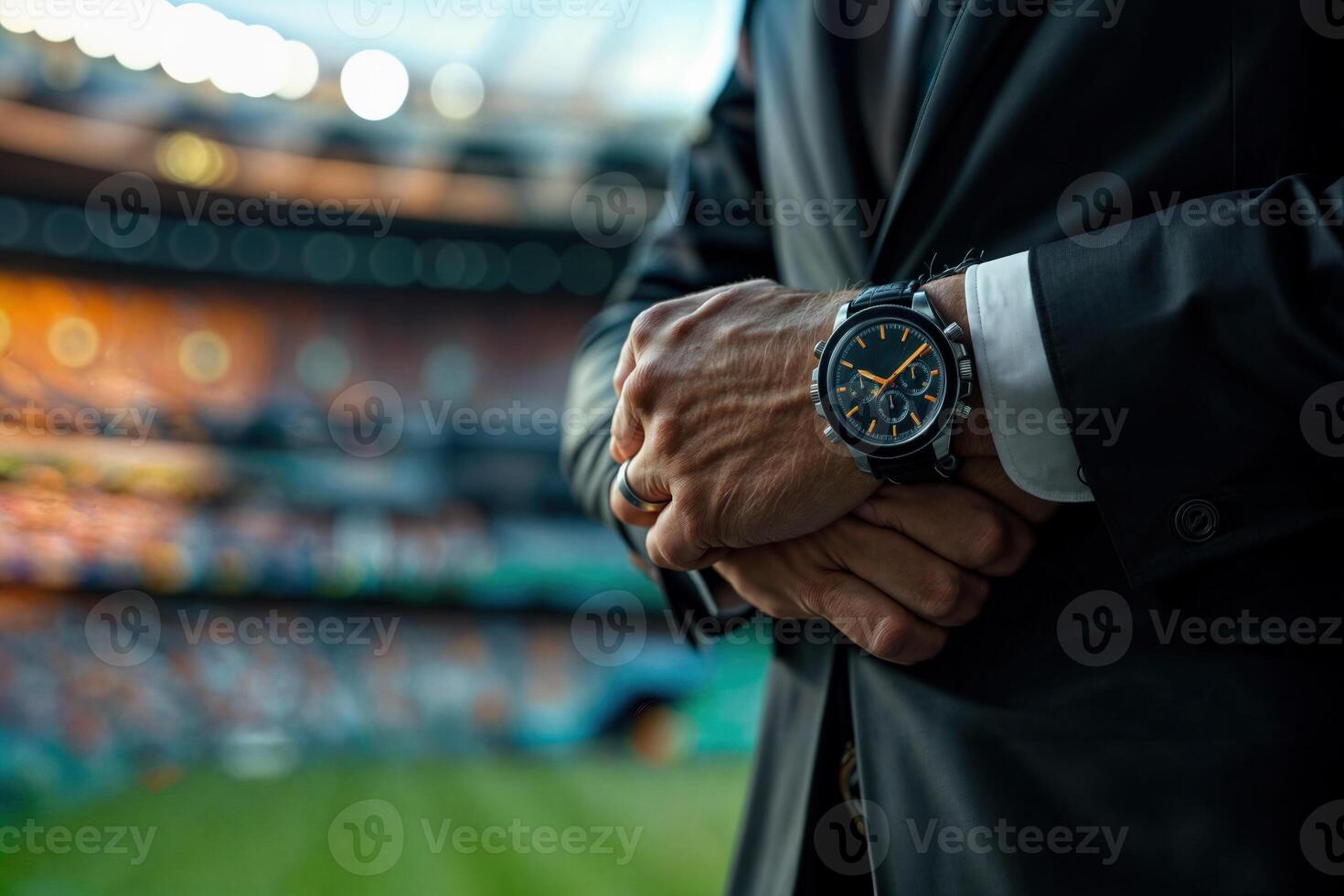 Businessman checking time at sports event photo
