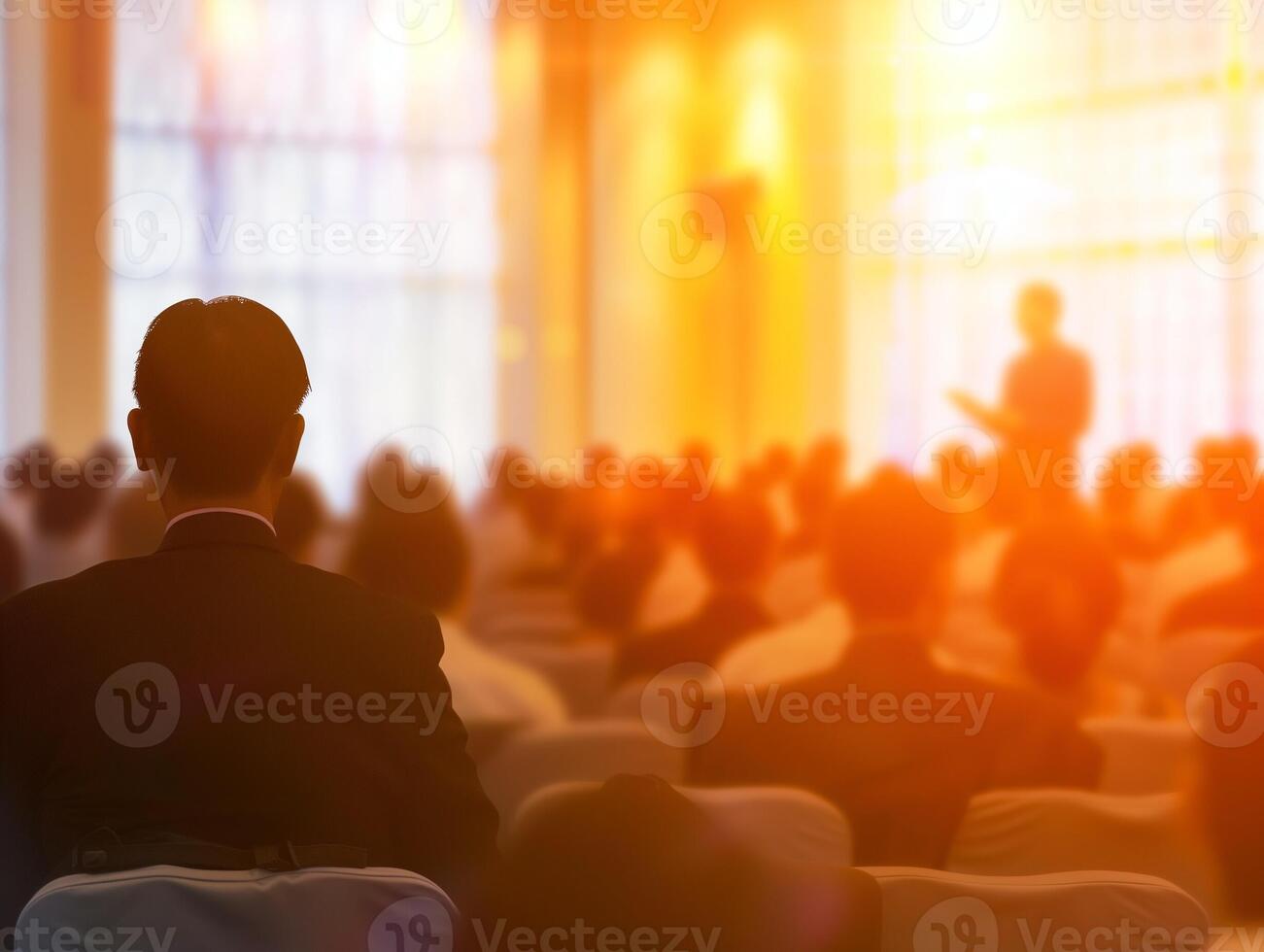 Business seminar with an attentive audience and warm blurred background photo